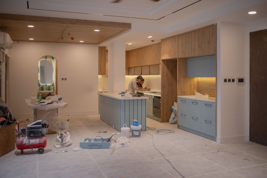 Crew installing cabinets and finishes in a kitchen remodel